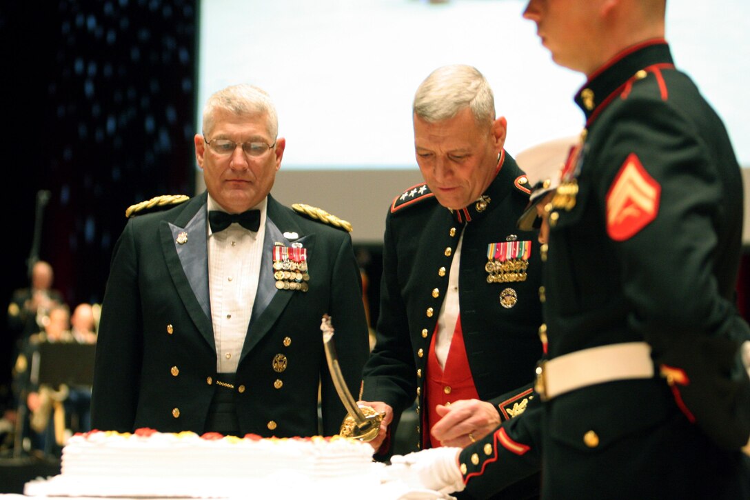 Major General John M. Paxton Jr., commander of U.S. Marine Corps Forces, Europe, cuts the first piece of cake for the guest-of-honor, Gen. Carter F. Ham, commanding general for U.S. Africa Command, as part of the traditional ceremony during the 237th Marine Corps Birthday Ball celebration for U.S. Marine Corps Forces, Europe, and U.S. Marine Corps Forces, Africa, November 10. Marines, along with their USAG Stuttgart community, gathered at the Messe, a hotel in Vaihingen, Germany, to uphold the traditions and customs celebrated every year for the Marine Corps Birthday. 