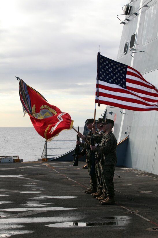 A Marine Corps color guard with the 24th Marine Expeditionary Unit lowers the Marine Corps flag for the National Anthem on the flight deck of the USS New York during a cake-cutting ceremony to celebrate the Marine Corpsâ€™ 237th birthday, Nov. 10, 2012. This was the first of perhaps many more Marine Corps birthday celebrations aboard the New York, built with seven-and-a-half tons of steel from the World Trade Center, as she sails on her maiden deployment. The 24th MEU is deployed with the Iwo Jima Amphibious Ready Group and is currently in the 6th Fleet Area of Responsibility as a disaster relief and crisis response force. Since deploying in March, they have supported a variety of missions in the U.S. Central and European Commands, assisted the Navy in safeguarding sea lanes, and conducted various bilateral and unilateral training events in several countries in the Middle East and Africa. The 24th MEU is scheduled to return to their home bases in North Carolina later this year. (U.S. Marine Corps photo by Staff Sgt. Robert Fisher III/Released)