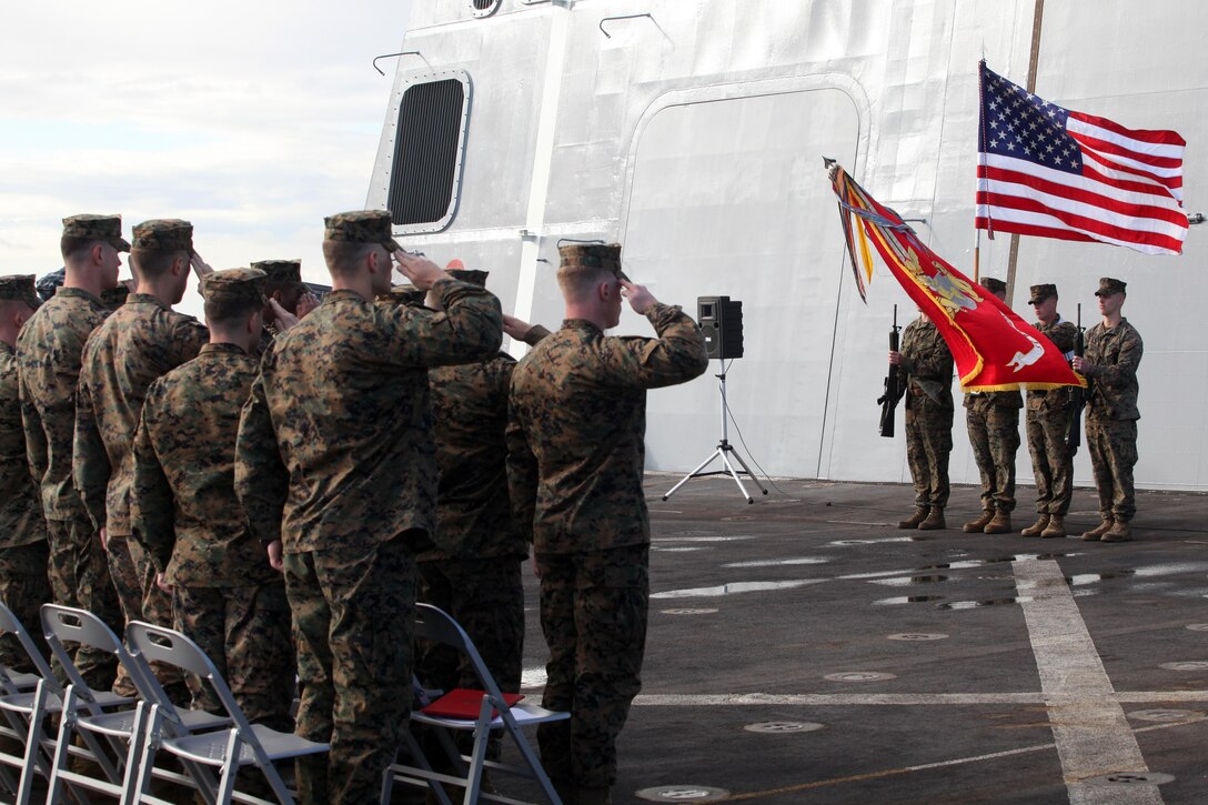 Marines with the 24th Marine Expeditionary Unit salute the American flag during the National Anthem as part of a cake-cutting ceremony on the flight deck of the USS New York to celebrate the Marine Corpsâ€™ 237th birthday, Nov. 10, 2012. This was the first of perhaps many more Marine Corps birthday celebrations aboard the New York, built with seven-and-a-half tons of steel from the World Trade Center, as she sails on her maiden deployment. The 24th MEU is deployed with the Iwo Jima Amphibious Ready Group and is currently in the 6th Fleet Area of Responsibility as a disaster relief and crisis response force. Since deploying in March, they have supported a variety of missions in the U.S. Central and European Commands, assisted the Navy in safeguarding sea lanes, and conducted various bilateral and unilateral training events in several countries in the Middle East and Africa. The 24th MEU is scheduled to return to their home bases in North Carolina later this year. (U.S. Marine Corps photo by Staff Sgt. Robert Fisher III/Released)