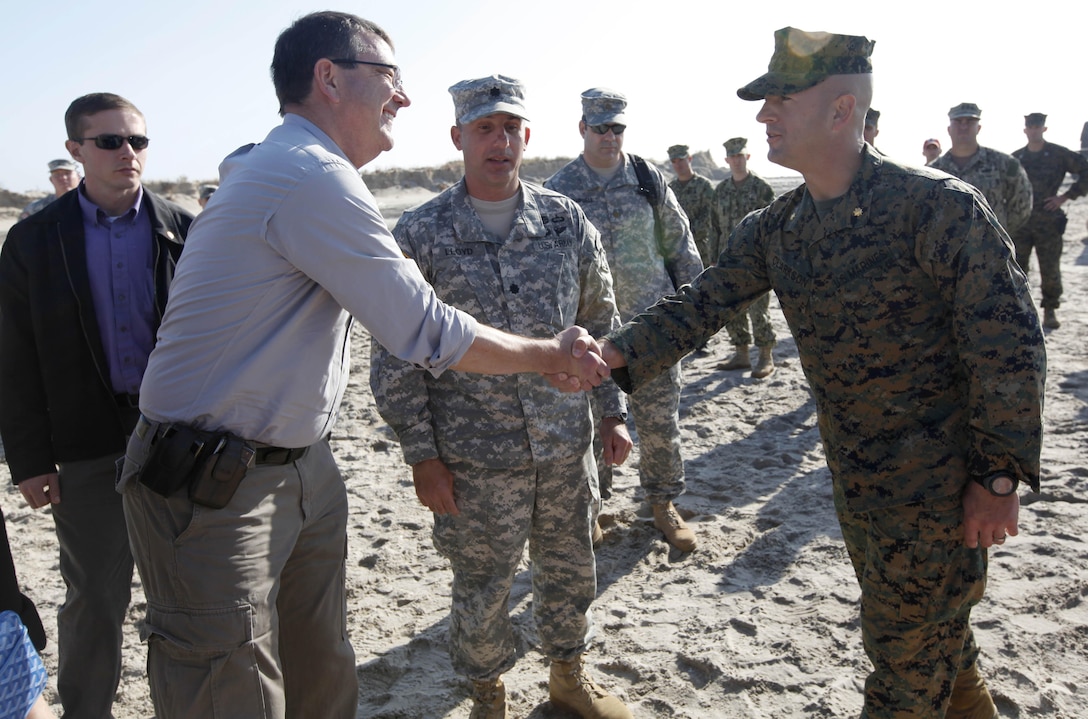 Ashton B. Carter, the United States deputy secretary of defense shakes hands with Maj. Craig Clarkson, the commanding officer of the 8th Engineer Support Battalion, 2nd Marine Logistics Group detachment in New York in Breezy Point, N.Y. Nov. 12. Carter visited Breezy Point to observe the work being done, and he wanted to thank the service members who are part of the reief effort. 