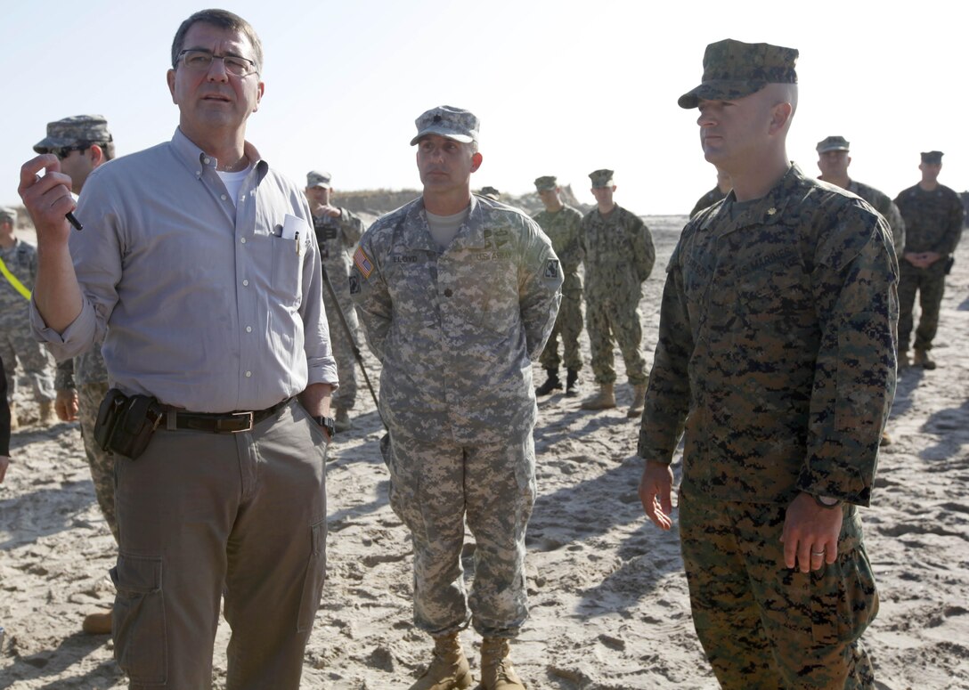 Ashton Carter, the United States Deputy Secretary of Defense, and Maj. Craig Clarkson, the commanding officer of 8th Engineer Support Battalion, 2nd  Marine Logistics Group in New York discuss the relief efforts the Marines have been conducting the past couple of weeks in Breezy Point, N.Y. Nov. 12. Carter visited Breezy Point to see the progress of the joint-service reilef effort in the area.