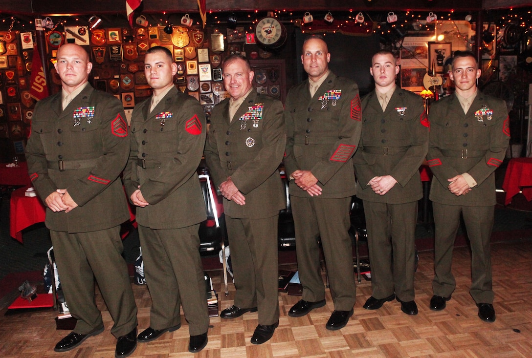 Corporal Denver C. Creasey (second from left), an automotive maintenance technician with 2nd Marine Special Operations Battalion, U.S. Marine Corps Forces, Special Operations Command, poses for a photo with fellow recipients of the John Archer Lejeune Award for Bravery at Sywanyk's Scarlet and Gold club in Jacksonville, NC Oct. 26. Creasey, who was recognized as part of the 6th Annual American Hero Awards, ran into a burning building to alert sleeping Marines of a fire. (U.S. Marine Corps photo by Lance Cpl. Nik S. Phongsisattanak/Released)
