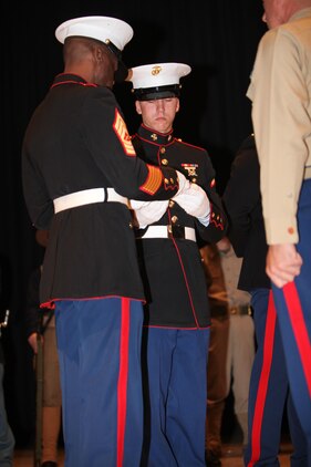 Pfc. Robert E. Kilgore JR., the youngest Marine, recieves a peice of cake from the Master Sgt. Leonard B. Crooms, the oldest Marine, during the cake cutting ceremony of the Cherry Point 237th Marine Corps Ball Ceremony at the station theater Nov. 8.