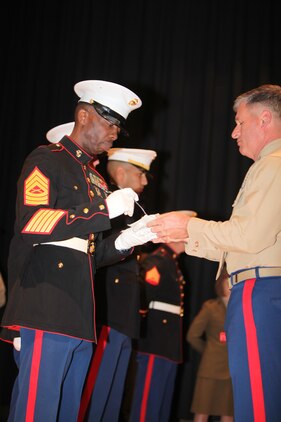 Master Sgt. Leonard B. Crooms, the oldest Marine in attendance, recieves the first slice of cake from Col. Philip J. Zimmerman, the commanding officer of MCAS Cherry Point during the cake cutting ceremony of the Cherry Point 237th Marine Corps Ball Ceremony at the station theater Nov. 8.