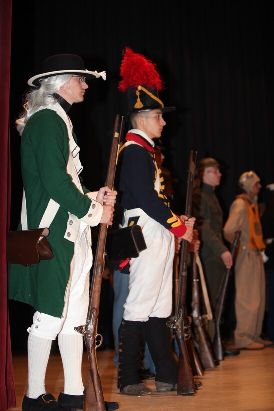 Lance Cpl. Justin Sweet, dressed as the Marine of the Revolutionary War, left, and Lance Cpl. Tyler Lund, dressed as a Marine from the War of 1812, right, stand at parade rest during the Cherry Point 237th Marine Corps Ball Ceremony at the station theater Nov. 8.