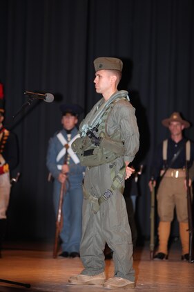 Capt. Greg Weber, dressed as a modren Marine aviator, speaks about the impact of Marine Corps aviation on the fight and mission of the USMC during the Cherry Point 237th Marine Corps Ball Ceremony at the station theater Nov. 8.