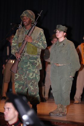 Dressed in the uniforms from the southeast Asia lance corporals Kashay Patterson, left, and Angela Lawrence, right, speaks about the Marine Corps impact on their time frame during the Cherry Point 237th Marine Corps Ball Ceremony at the station theater Nov. 8.