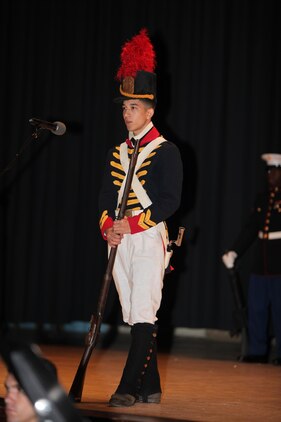 Lance Cpl. Tyler Lund is dressed as a Marine from the War of 1812 and speaks about the growing resilience of the Marine Corps during the Cherry Point 237th Marine Corps Ball Ceremony at the station theater Nov. 8.