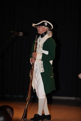 Dressed as an original uniformed Marine, Lance Cpl. Justing Sweet speaks about the birth of the Marine Corps on November 10, 1775 during the Cherry Point 237th Marine Corps Ball Ceremony at the station theater Nov. 8.