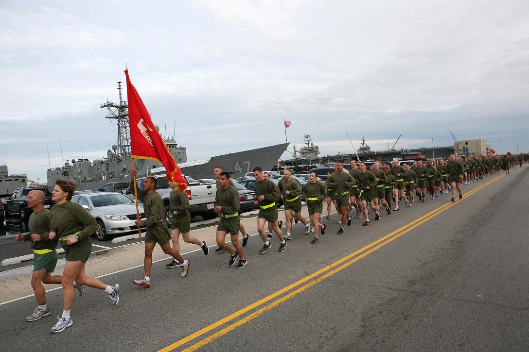 NORFOLK (Nov. 8, 2012) - Col. Susan Seaman, commanding officer, Headquarters and Service Battalion, Marine Forces Command and Sgt. Maj. Scott Helms, lead a formation run along the peir of Naval Station Norfolk to commemorate the 237th Marine Corps Birthday.