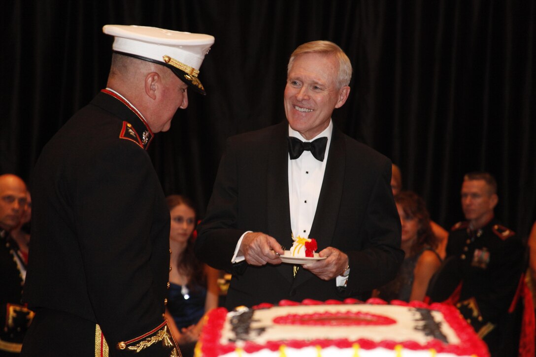 Maj. Gen. Glenn M. Walters, commanding general of the 2nd Marine Aircraft Wing, hands Secretary of the Navy Ray Mabus a piece of the Marine Corps birthday cake during the wing’s 237th Marine Corps birthday ball celebration in New Bern, N.C., Nov. 7. Mabus said the night was all about celebrating history, tradition, and heritage.