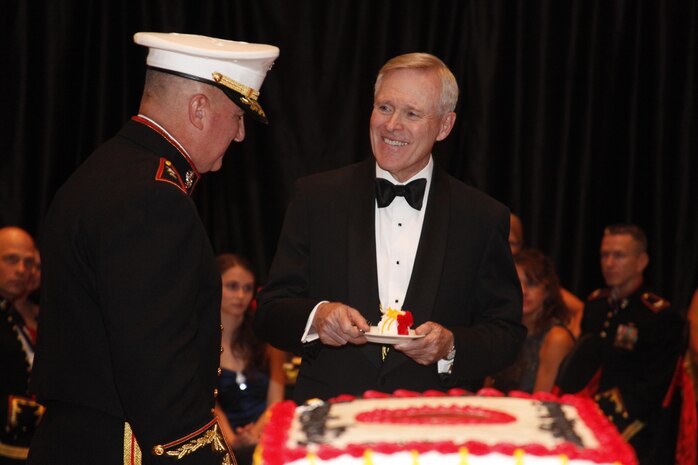 Maj. Gen. Glenn M. Walters, commanding general of the 2nd Marine Aircraft Wing, hands Secretary of the Navy Ray Mabus a piece of the Marine Corps birthday cake during the wing’s 237th Marine Corps birthday ball celebration in New Bern, N.C., Nov. 7. Mabus said the night was all about celebrating history, tradition, and heritage.
