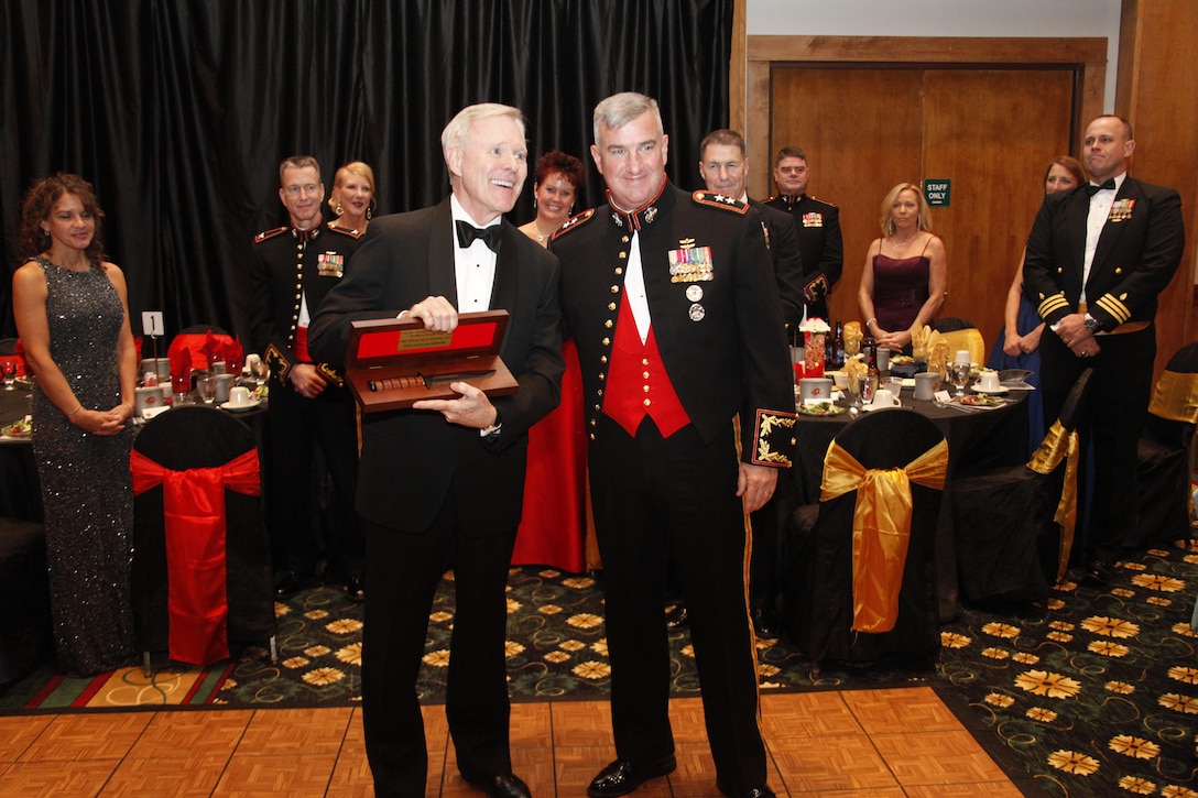 Maj. Gen. Glenn M. Walters, commanding general of the 2nd Marine Aircraft Wing, presents Secretary of the Navy Ray Mabus with a gift for serving as the MAW’s guest of honor at its 237th Marine Corps birthday ball in New Bern, N.C., Nov. 7.  It is traditional for units to present a token of appreciation to guests of honor at Marine Corps balls around the world.