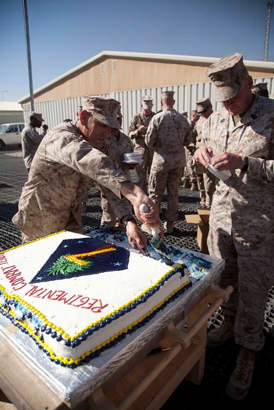 U.S. Marine Corps Sgt. Maj. Scott A. Samuels (left), Regimental Sergeant Major, Regimental Combat Team 7, and 1st Sgt. Gary R. Lomelino Jr.,  Headquarters Company, Regimental Combat Team 7, serve cake to the Marines following the cake cutting ceremony on Camp Leatherneck, Helmand province, Afghanistan, Nov. 10, 2012.The Marines of Headquarters Company, Regimental Combat Team 7, conducted this ceremony to celebrate the Marine Corps 237th birthday. (U.S. Marine Corps photo by Cpl. Alejandro Pena/Released)