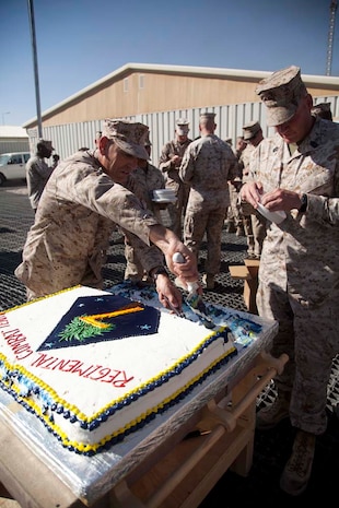 U.S. Marine Corps Sgt. Maj. Scott A. Samuels (left), Regimental Sergeant Major, Regimental Combat Team 7, and 1st Sgt. Gary R. Lomelino Jr.,  Headquarters Company, Regimental Combat Team 7, serve cake to the Marines following the cake cutting ceremony on Camp Leatherneck, Helmand province, Afghanistan, Nov. 10, 2012.The Marines of Headquarters Company, Regimental Combat Team 7, conducted this ceremony to celebrate the Marine Corps 237th birthday. (U.S. Marine Corps photo by Cpl. Alejandro Pena/Released)
