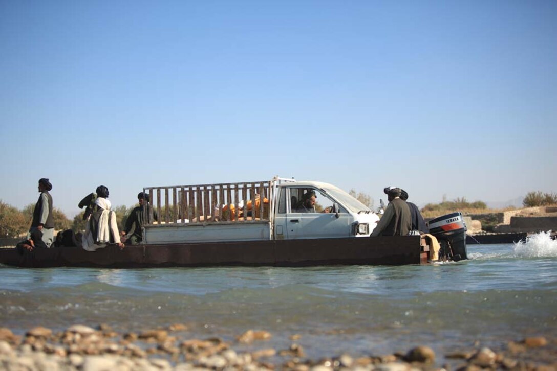 A ferryboat taxis local villagers across the Helmand River in Sangin, Afghanistan, Nov. 10, 2012. Currently, the local populace has the options of taking the ferry, walking through the river at certain passable areas or taking a detour more than 55 kilometers out of the way to get across the river.