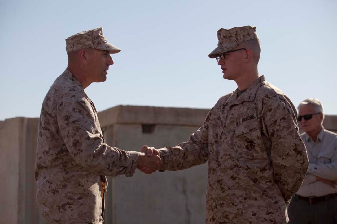 U.S. Marine Corps Sgt. Maj. Scott A. Samuels (left), Sergeant Major, Regimental Combat Team 7, recognizes  Pfc. Clifford C. Dietrich, the youngest Marine present, prior to a cake cutting ceremony on Camp Leatherneck, Helmand province, Afghanistan, Nov. 10, 2012. The ceremony was conducted in celebration of the Marine Corps 237th birthday. (U.S. Marine Corps photo by Cpl. Alejandro Pena/Released)