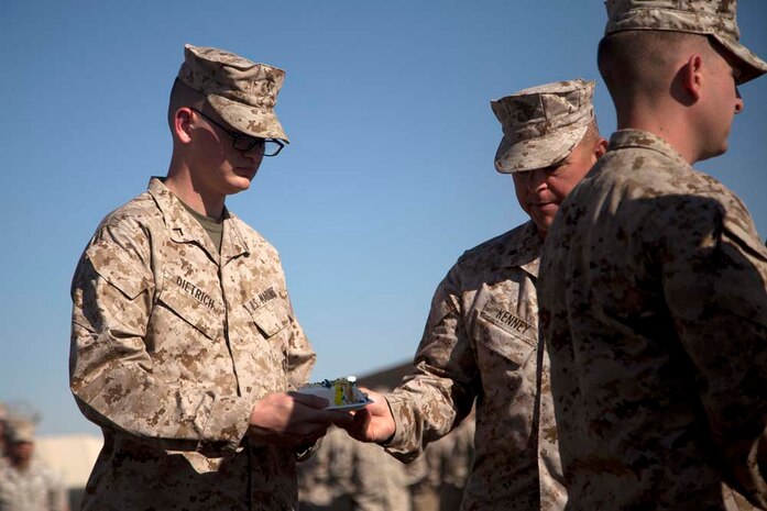 Lt. Col. Jeffrey Kenney hands the second piece of cake to Pfc. Clifford Dietrich during Regimental Combat Team 7â€™s Marine Corps birthday ceremony, at Camp Leatherneck, Nov. 10. As is tradition, Dietrich, the youngest Marine present during RCT-7â€™s ceremony, received the second piece of cake from Kenney, the oldest Marine. For Dietrich, this was a first. Dietrich, a data helpdesk clerk with RCT-7, is from Ocala, Fla. (Photo by Marine Cpl. Alejandro Pena)