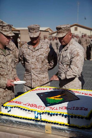 U.S. Marine Corps Col. Austin E. Renforth, right, Commanding Officer 7th Marine Regiment, cuts a piece of cake during a cake cutting ceremony on Camp Leatherneck, Helmand province, Afghanistan, Nov. 10, 2012. The ceremony was conducted in celebration of the Marine Corps 237th birthday. (U.S. Marine Corps photo by Cpl. Alejandro Pena/Released)