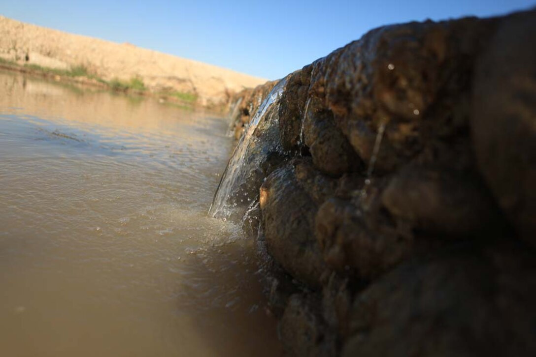 Diverted water spills into the causeway on the Helmand River in Sangin District, Afghanistan, Nov. 10, 2012. The Helmand River has swelled throughout the years prompting the need for Operation Golden Gate in the Sangin District. The operation is a combined effort to build a bridge more than 24 feet wide that will span more than 150 feet across the Helmand River, allowing for easy passage for the local people.