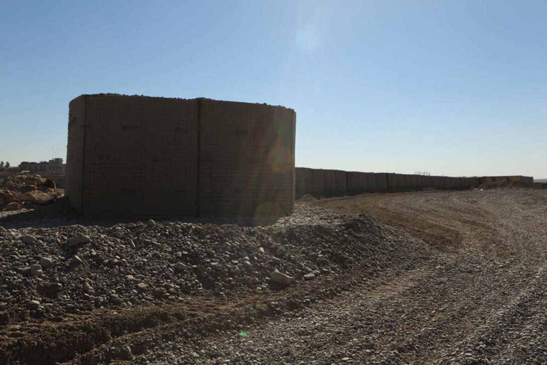 HESCO barriers line the bank of the Helmand River as part of Operation Golden Gate in Sangin, Afghanistan, Nov. 10, 2012. The barriers will aid in placing the bridge that will stretch across the river.
