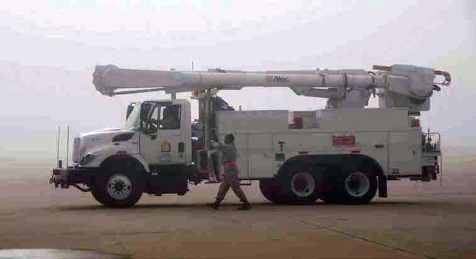 A Southern California Edison bucket truck is cautiously marshaled by a March
reservist through the dense fog that blanketed the March Field flightline during
Hurricane Sandy relief efforts, Nov. 1, 2012. Vehicles were loaded onto C-17
Globemaster III and C-5 Galaxy aircraft, for transportation to the east coast to assist
with power restoration operations. (U.S. Air Force photo by Darnell Gardner)