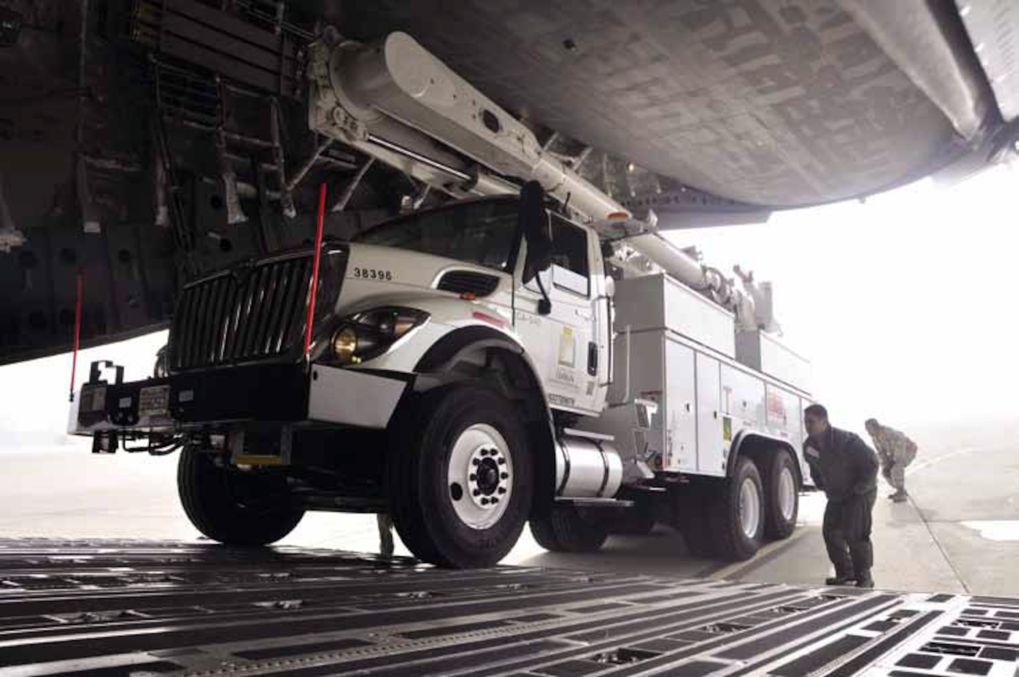 Reservists and technicians from March Air Reserve Base, Calif., carefully load
a Southern California Edison line truck onto a Joint Base Lewis-McChord C-17
Globemaster III, Nov. 1, 2012. The vehicles will be used to restore power to the
areas affected by Hurricane Sandy. (U.S. Air Force photo by Darnell Gardner)
