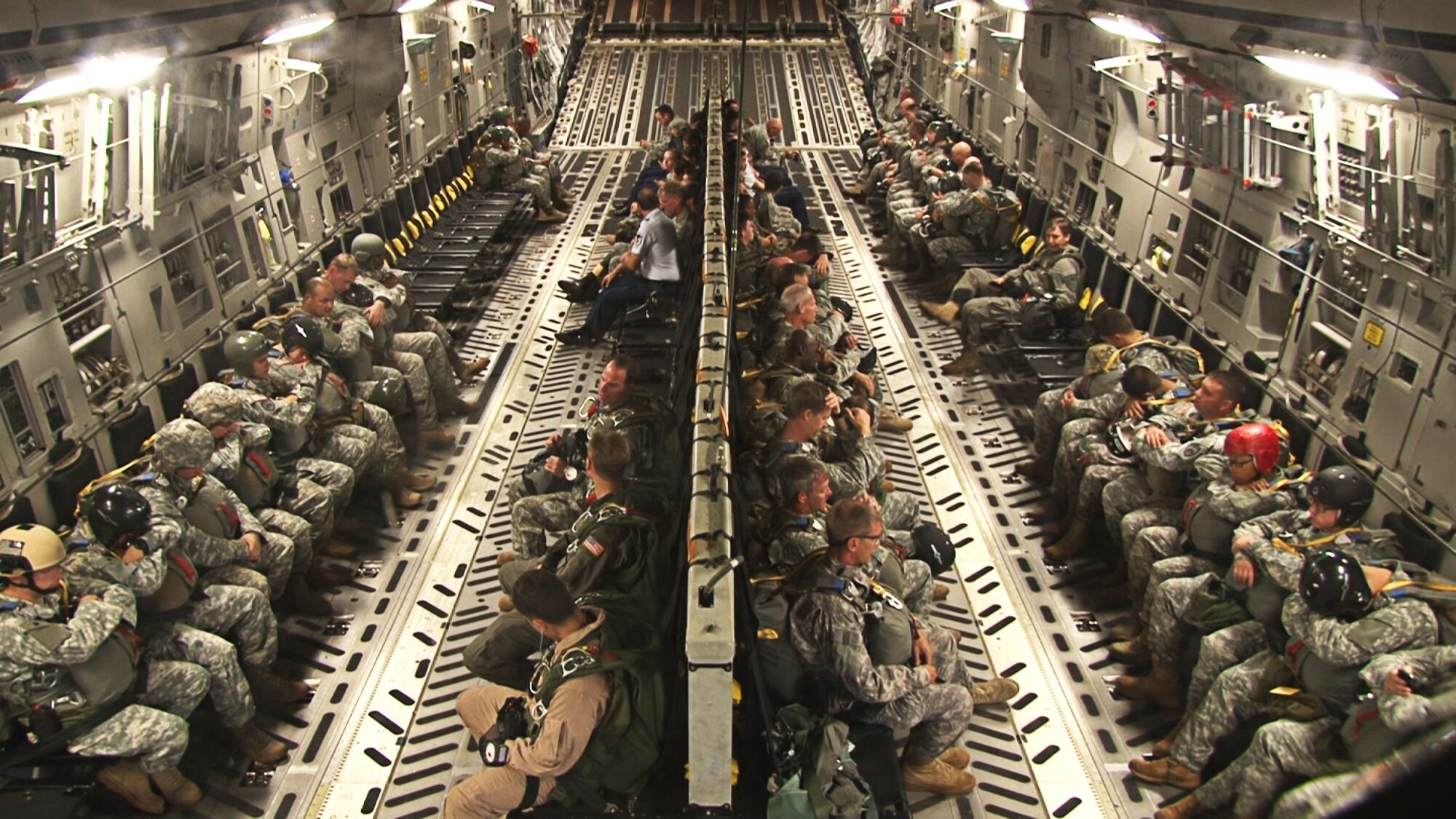 Junior Reserve Officer Training Corps cadets from six highschools around Oahu and joint-service paratroopers fly aboard a C-17 Globemaster III operated by an aircrew from the 535th Airlift Squadron at Joint Base Pearl Harbor-Hickam, Hawaii, Nov. 13. During the flight, 41 cadets were able to observe various C-17 capabilities such as the ability to drop "static-line" jumpers, "high-altitude, low-opening" jumpers, and the performance of an "assault" landing at Kaneohe Bay Marine Corps Base, Hawaii. (U.S. Air Force photo/ Staff Sgt. Nathan Allen)