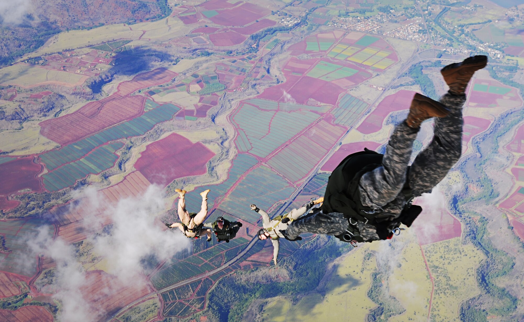 Joint-service paratroopers jump out of a C-17 Globemaster III operated by an aircrew from the 535th Airlift Squadron at Joint Base Pearl Harbor-Hickam, Hawaii, Nov. 13. During the flight, 41 Junior Reserve Officer Training Corps cadets from six high schools across Oahu were able to observe various C-17 capabilities such as the ability to drop "static-line" jumpers, "high-altitude, low-opening" jumpers, and the performance of an "assault" landing at Kaneohe Bay Marine Corps Base, Hawaii. (U.S. Air Force photo/ Staff Sgt. Nathan Allen)