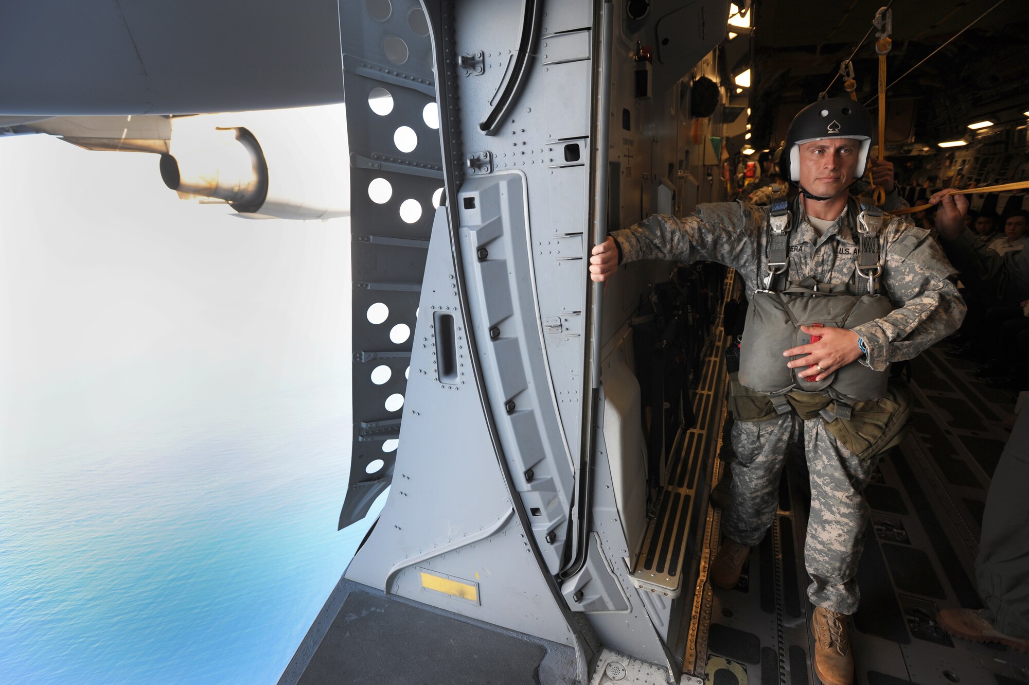 Joint-service paratroopers prepare to step off a C-17 Globemaster III operated by an aircrew from the 535th Airlift Squadron at Joint Base Pearl Harbor-Hickam, Hawaii, Nov. 13. During the flight, 41 Junior Reserve Officer Training Corps cadets from six high schools across Oahu were able to observe various C-17 capabilities such as the ability to drop "static-line" jumpers, "high-altitude, low-opening" jumpers, and the performance of an "assault" landing at Kaneohe Bay Marine Corps Base, Hawaii. (U.S. Air Force photo/ Staff Sgt. Nathan Allen)