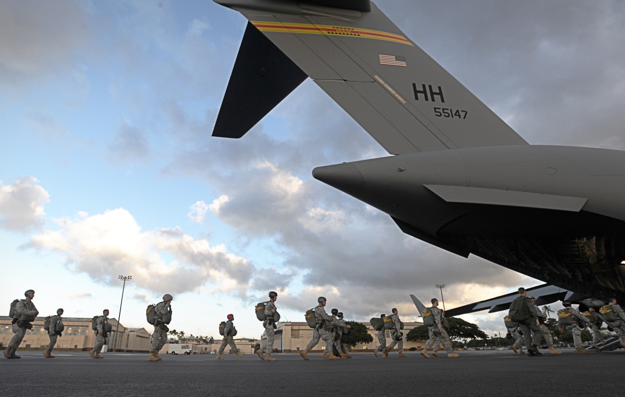 Joint-service paratroopers walk onto a C-17 Globemaster III operated by an aircrew from the 535th Airlift Squadron at Joint Base Pearl Harbor-Hickam, Hawaii, Nov. 13. During the flight, 41 Junior Reserve Officer Training Corps cadets from six high schools across Oahu were able to observe various C-17 capabilities such as the ability to drop "static-line" jumpers, "high-altitude, low-opening" jumpers, and the performance of an "assault" landing at Kaneohe Bay Marine Corps Base, Hawaii. (U.S. Air Force photo/ Staff Sgt. Nathan Allen)