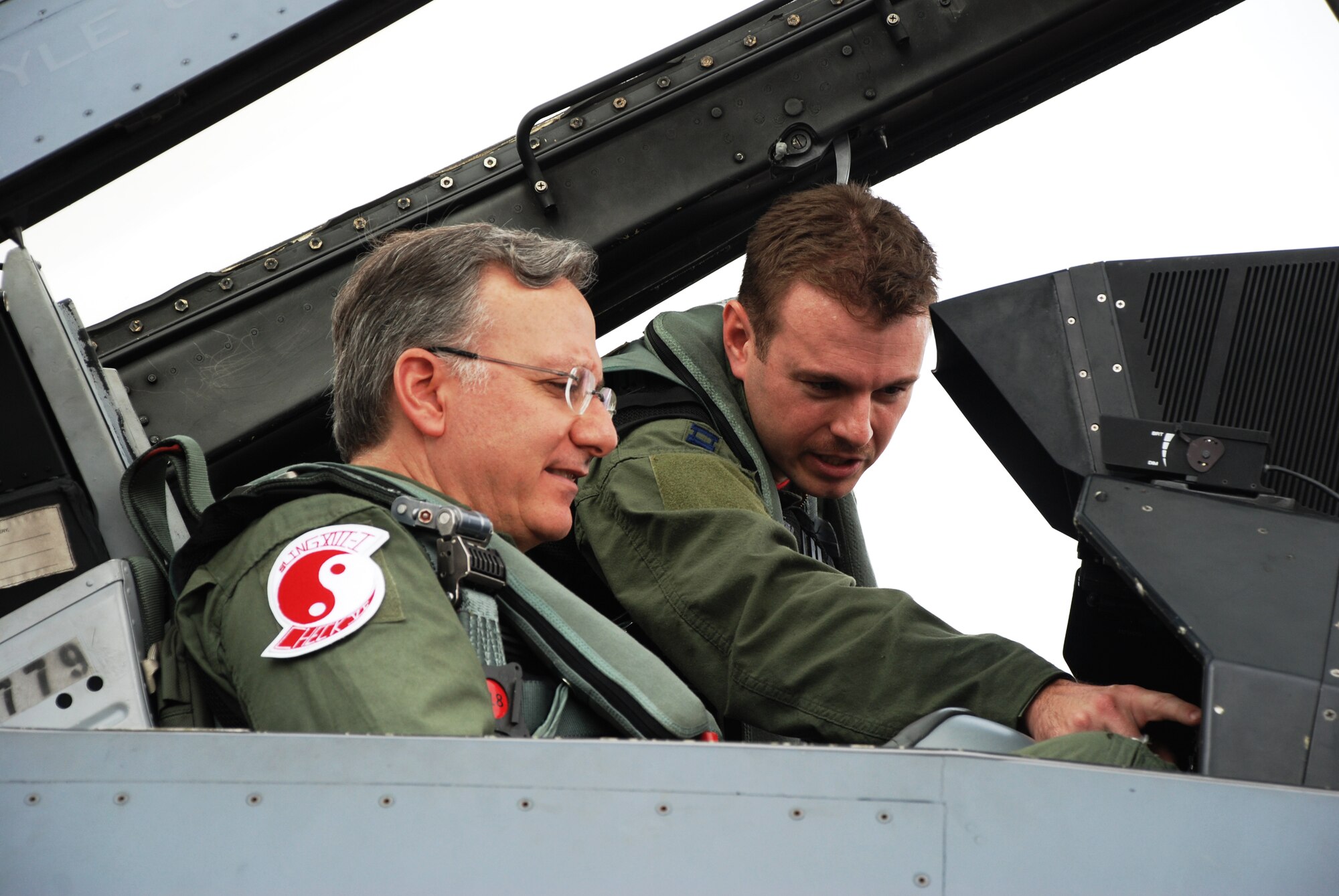 Capt. Tyler Smith, 36th Fighter Squadron pilot, shows U.S. Ambassador to Singapore David Adelman an F-16 Fighting Falcon flight display and instrumentation before flying during a combat training sortie at Paya Lebar Air Base, Oct. 24, 2012. The 36th Expeditionary Fighter Squadron deployed 77 members in support of the Joint Chiefs of Staff- directed exercise Commando Sling in October 2012 to sharpen air combat skills through combined air combat training with the Republic Singapore Air Force. (Courtesy photo)