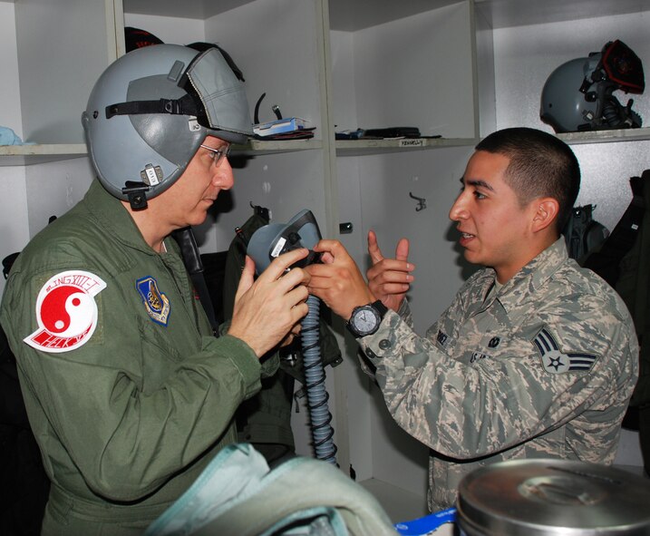 Senior Airman David Gutierrez, 51st Operations Support Squadron life support technician, explains the intricacies of helmet and mask to U.S. Ambassador to Singapore David Adelman at Paya Lebar Air Base, Oct. 19, 2012. The 36th Expeditionary Fighter Squadron provided Adelman a better understanding of U.S. Air Force capabilities during Team Osan’s deployment to Singapore for Commando Sling 2012. (Courtesy photo) 

