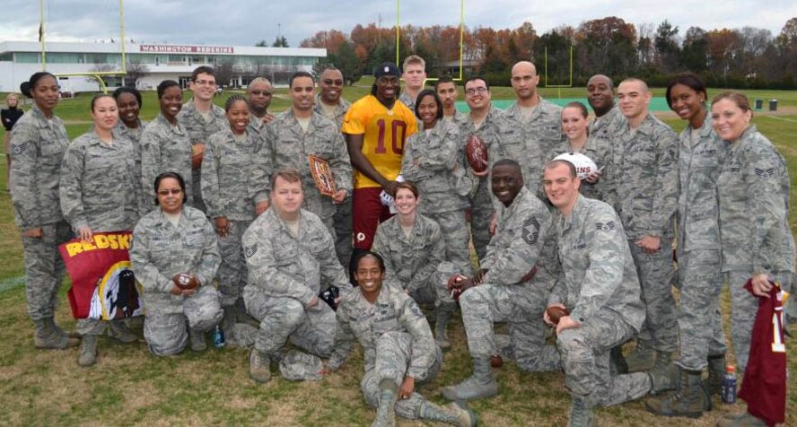 Air Force District of Washington Airmen and National Football League Washington Redskins Quarterback Robert Griffin III enjoy USAA?s "Salute to Service" event at the Redskins practice, Nov. 12, 2012, in Landover, Md. The Airmen who spent time with Redskins players and coaches are currently stationed with units from Joint Base Andrews, Md. and Joint Base Anacostia-Bolling, D.C. (Courtesy photo)