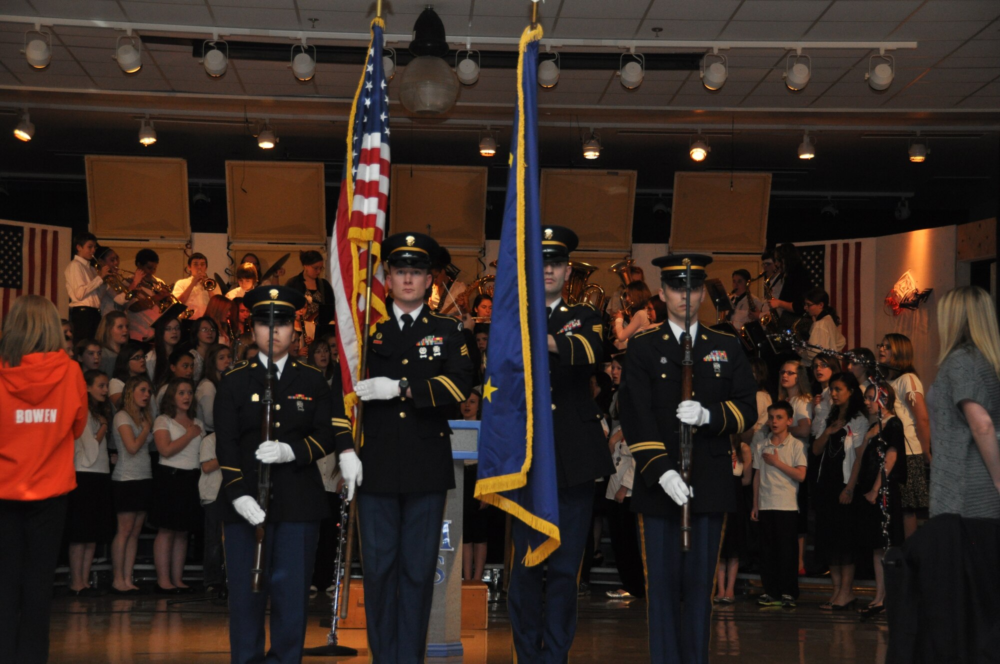 The Alaska Army National Honor Guard presents the colors as the Palmer Junior Middle School band and chorus perform the National Anthem during the Tribute to Veterans concert in Palmer Alaska Nov. 9, 2012.Veterans Day is a day to honor service members, past and present for their patriotism and willingness to serve the United States. (Air Force Reserve Photo/Tech. Sgt. Dana Rosso) 