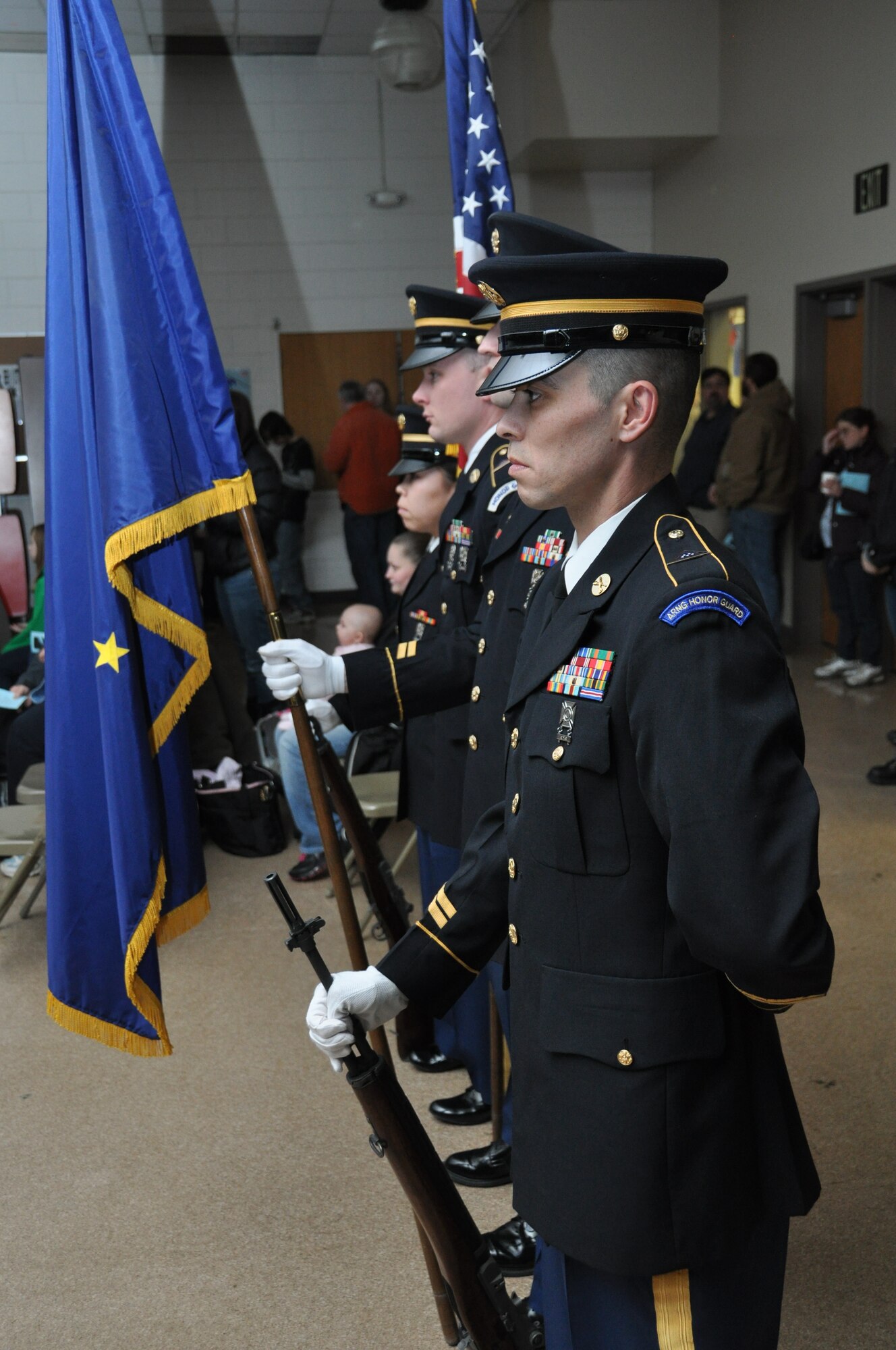 The Alaska Army National Honor Guard stands ready to present the colors during the Palmer Junior Middle School Tribute to Veterans concert in Palmer Alaska Nov. 9, 2012. Veterans Day originated as “Armistice Day” on Nov. 11, 1919 the first anniversary of the conclusion of World War I. In 1954 following the aftermath of World War II and the Korean War, Armistice Day became Veterans Day, a holiday dedicated to American veterans. (Air Force Reserve Photo/Tech. Sgt. Dana Rosso) 