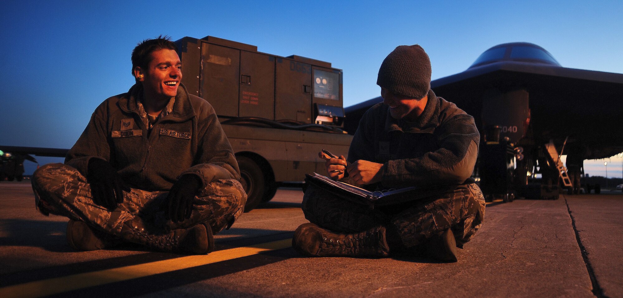 WHITEMAN AIR FORCE BASE, Mo. -- Staff Sgt. Mark Dixon, 509th Aircraft Maintenance Squadron dedicated crew chief, and Senior Airman Nathan Brogli, 509th AMXS assistant dedicated crew chief, share a laugh while reviewing aircraft forms Oct. 28. As technical experts on the B-2 Spirit, crew chiefs work directly with the aircraft, ensuring pilots have the most reliable, mission-capable plane possible to get the job done. (U.S. Air Force photo/Senior Airman Nick Wilson) (Released)