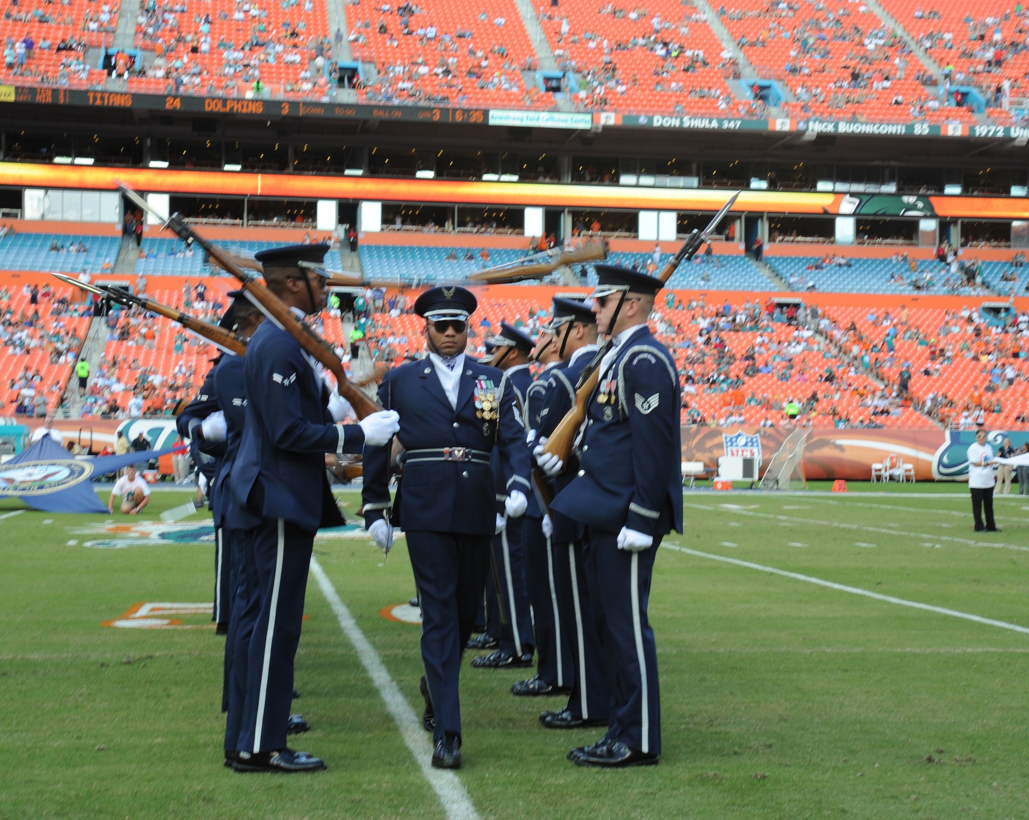 Master Sgt. Whitfield Jack, the Drill Team's flight chief, steps confidently forward as Drill Team members spin their bayonette-tipped M-1 rifles during the "Walk Through," portion of their performance Nov. 11, 2012, in Miami.  The Veteran's Day tribute honored veterans of military service both past and present.  (U.S. Air Force photo/Staff Sgt. Torey Griffith)