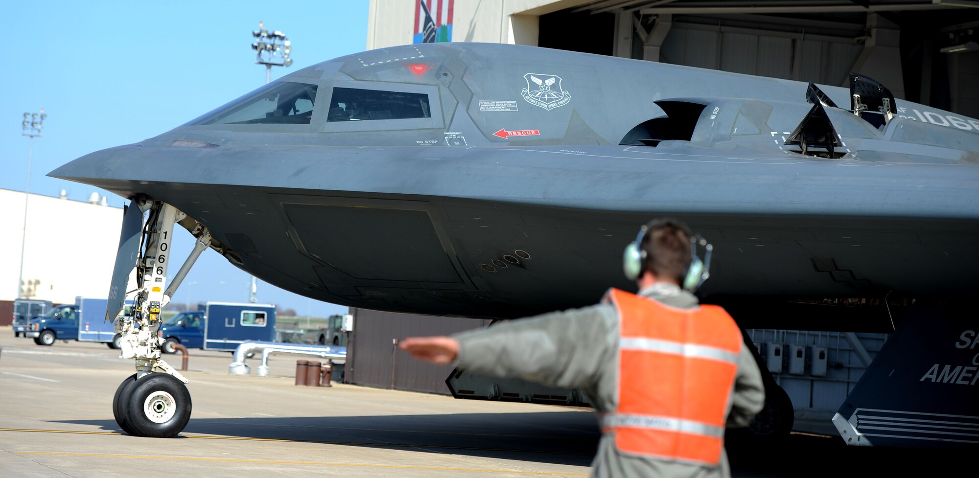 WHITEMAN AIR FORCE BASE, Mo. -- Airman 1st Class Patrick Nelson, 509th AMXS assistant dedicated crew chief, marshalls a B-2 Spirit Oct. 31. The B-2 brings massive firepower to bear, in a short time, anywhere on the globe through previously impenetrable defenses. (U.S. Air Force photo/Senior Airman Nick Wilson) (Released)