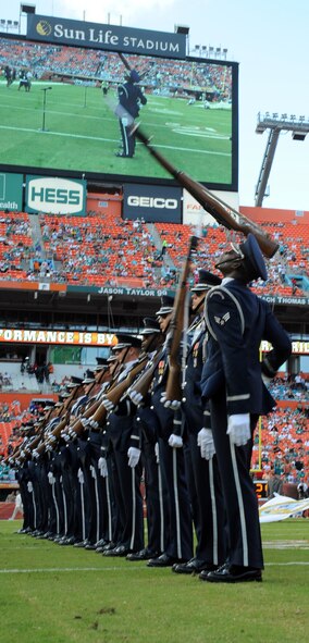 Members of the U.S. Air Force Honor Guard Drill Team toss their M-1 rifles in sequence as they perform "The Line" at the Miami Dolphins "Salute to Service" halftime show Nov. 11, 2012, in Miami.  The Veteran's Day tribute honored veterans of military service both past and present.  (U.S. Air Force photo/Staff Sgt. Torey Griffith)