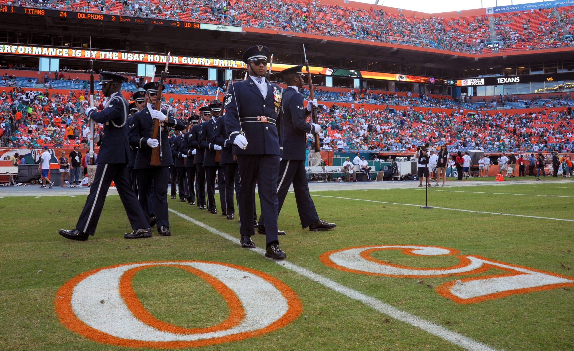 Members of the U.S. Air Force Honor Guard Drill Team begin their perfomance at the Miami Dolphins "Salute to Service" halftime show Nov. 11, 2012, in Miami.  The Veteran's Day tribute honored veterans of military service both past and present.  (U.S. Air Force photo/Staff Sgt. Torey Griffith)