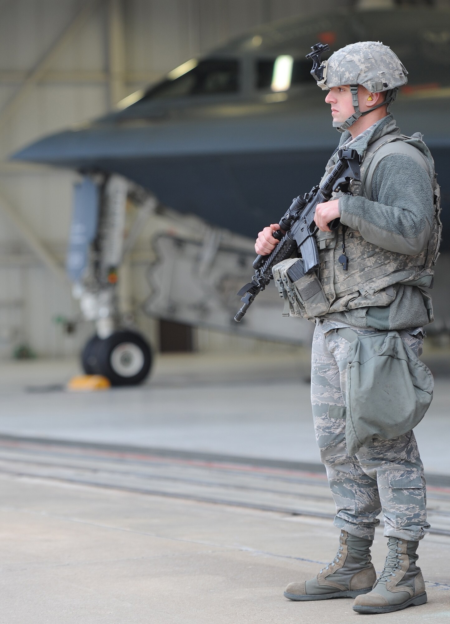 WHITEMAN AIR FORCE BASE, Mo. -- Airman 1st Class Tyler Moore, 509th Security Forces Squadron 509th Security Forces Squadron response force member, provides perimeter security for a B-2 Spirit Oct. 25. One of Moore’s responsibilities during this detail is to watch avenues of approach – ensuring no unauthorized entry into or out of the area. (U.S. Air Force photo/Senior Airman Nick Wilson) (Released)