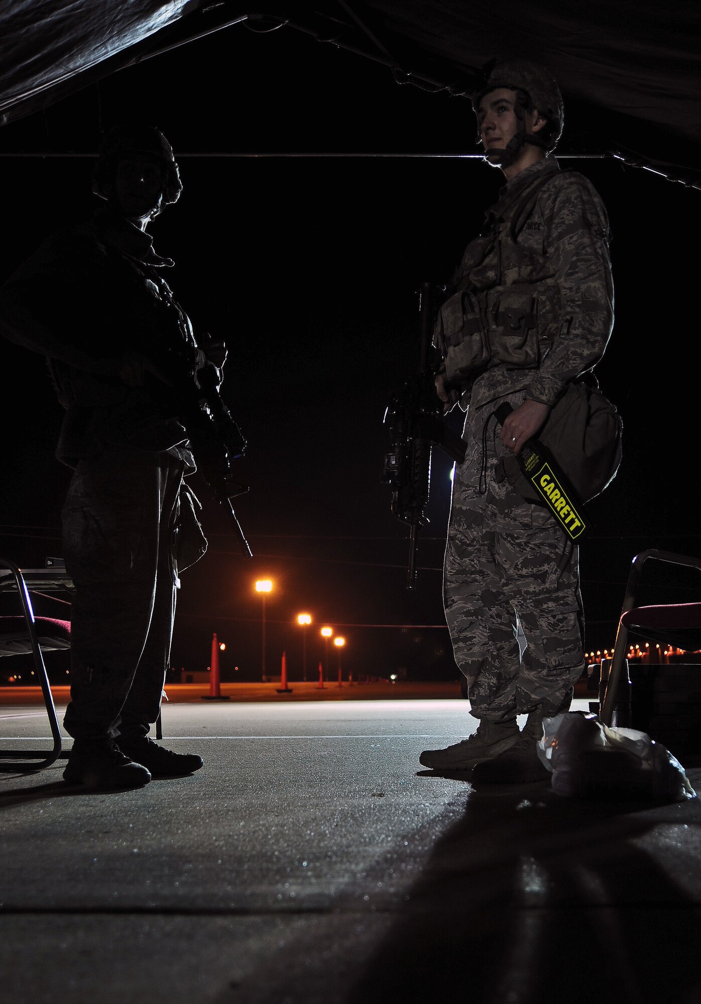 WHITEMAN AIR FORCE BASE, Mo. -- Senior Airman Steven Lewis, 509th Security Forces Squadron 509th Security Forces Squadron response force member, and Airman 1st Class Tyler Hewitt, 509th SFS 509th Security Forces Squadron response force member, discuss security procedures while guarding an entry control point Oct. 31. Like the mission that never sleeps, security forces Airmen are responsible for monitoring and defending installation assets 24/7. (U.S. Air Force photo/Senior Airman Nick Wilson) (Released)
