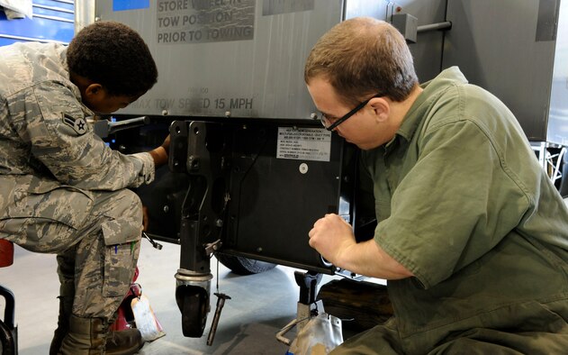 Airman 1st Class Toni Petty and Senior Airman Nicholas Chronister, 2nd Maintenance Squadron Aerospace Ground Equipment flight, perform a Time Compliance Technical Order on Barksdale Air Force Base, La., Nov. 13. TCTOs are modifications or updates to equipment to better adhere to safety standards. (U.S. Air Force photo/Airman 1st Class Andrew Moua)(RELEASED)