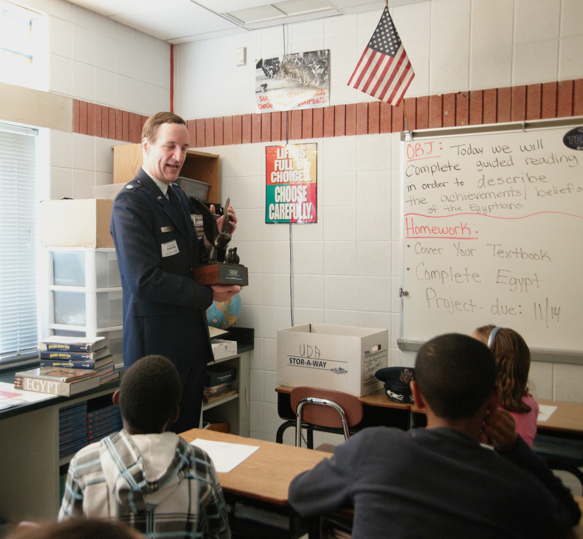 WALDORF, Md. - Retired Lt. Col. Phil Landweer shows  Mattawoman Middle School students the U.S. Air Force Academy Eagle and Fledgeling award at a Veterans Day program, Nov. 9, 2012. The inscription on the award states, “Man’s flight through life is sustained by the power of his knowledge.” (U.S. Air Force photo/ Senior Airman Amber Russell)