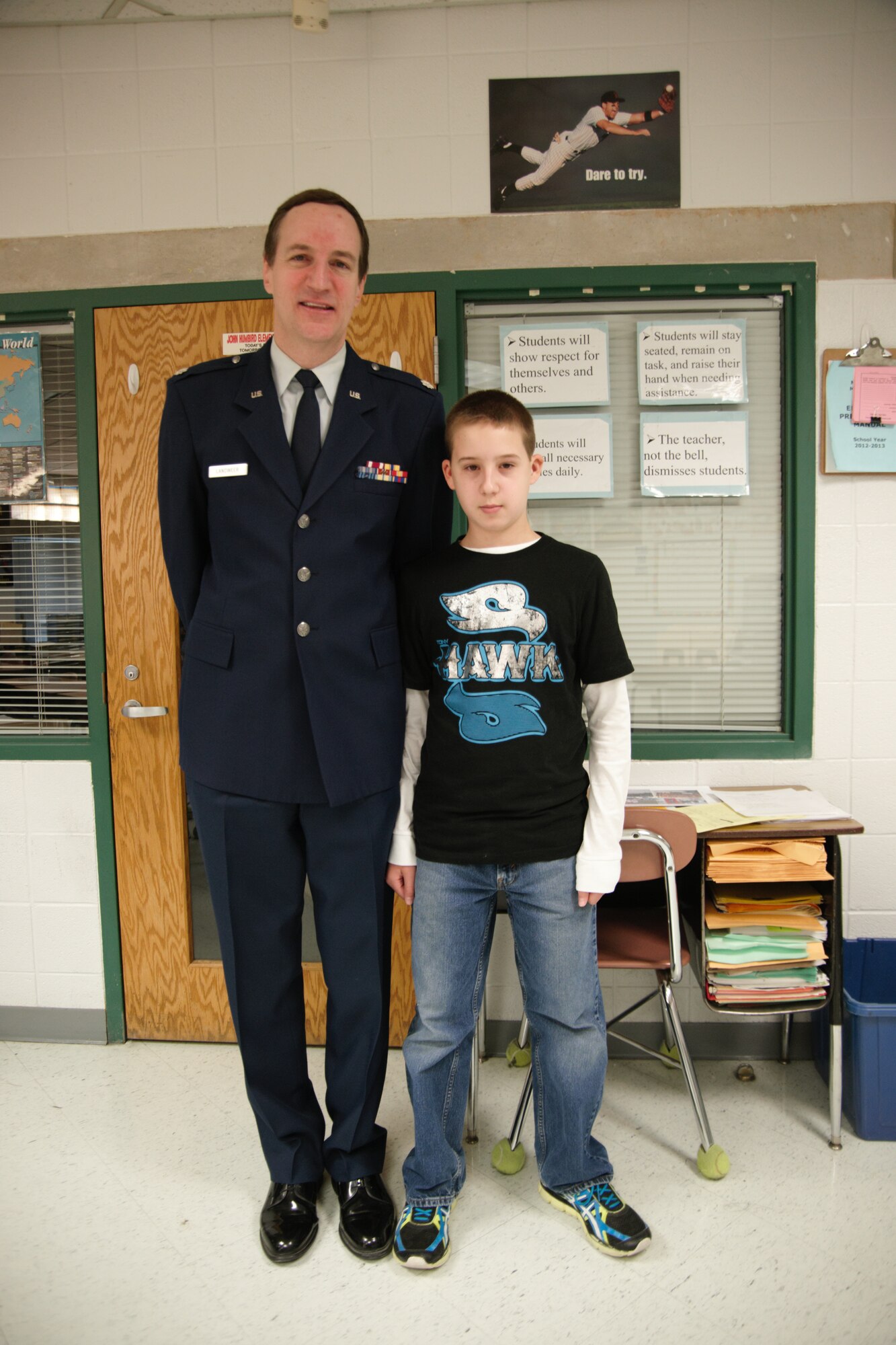 WALDORF, Md.- Retired Lt. Col. Phil Landweer stands with his grandson, sixth-grade Taylor Landweer, at  Mattawoman Middle Schools' Veterans Day program, Nov. 9, 2012.  Veterans spoke with nearly 150 students at the annual event.(U.S. Air Force photo/ Senior Airman Amber Russell)