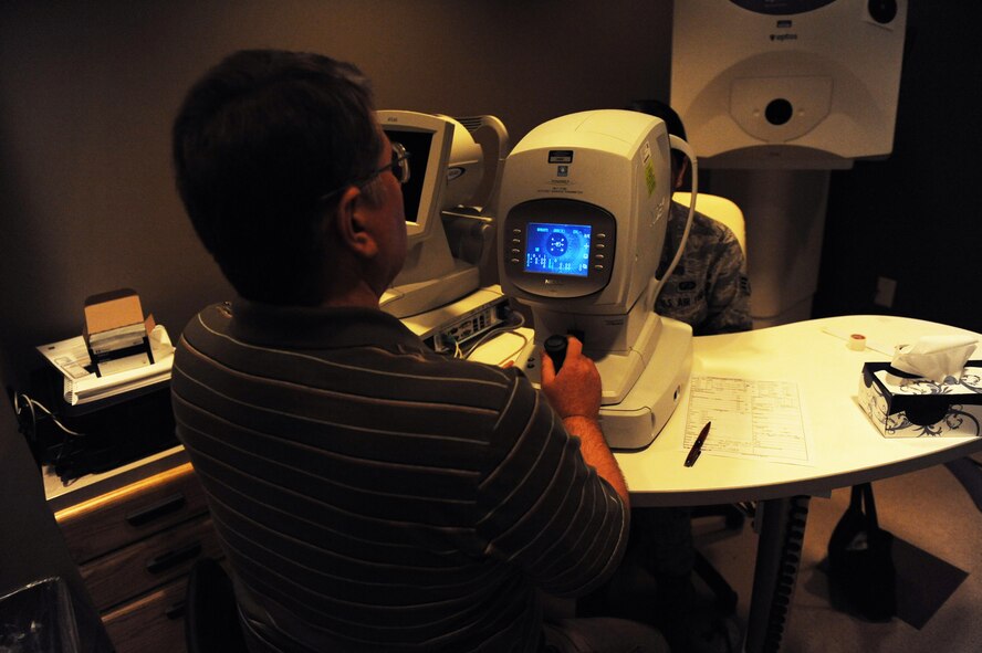 Michael Hoskins, 2nd Aerospace Medicine Squadron paraoptometric technician uses an auto-refractor on Senior Airman Karina Reyes, 2nd Contracting Squadron contracting specialist, during an eye exam on Barksdale Air Force Base, La., Nov. 14. The machine is used to obtain a baseline prescription for patients. (U.S. Air Force photo/Senior Airman Sean Martin)(RELEASED)