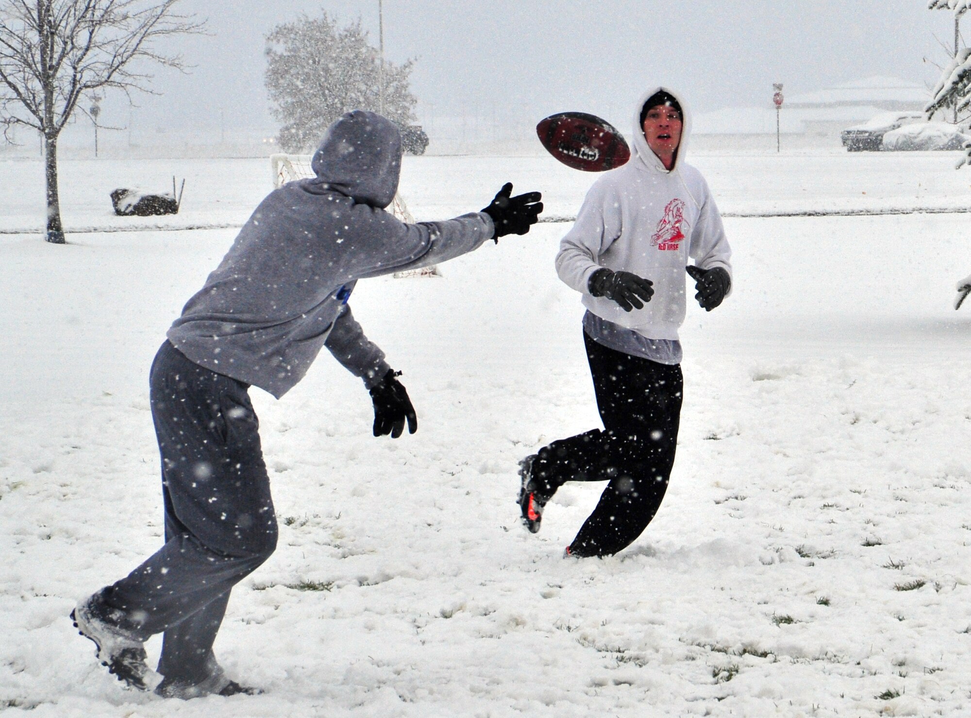 Members of the 92nd Contracting Squadron play a game of football during the first snowfall on Fairchild Air Force Base, Wash., Nov. 9, 2012. The snow depth reached three inches during the morning. (U.S. Air Force photo by Airman 1st Class Taylor Curry) 