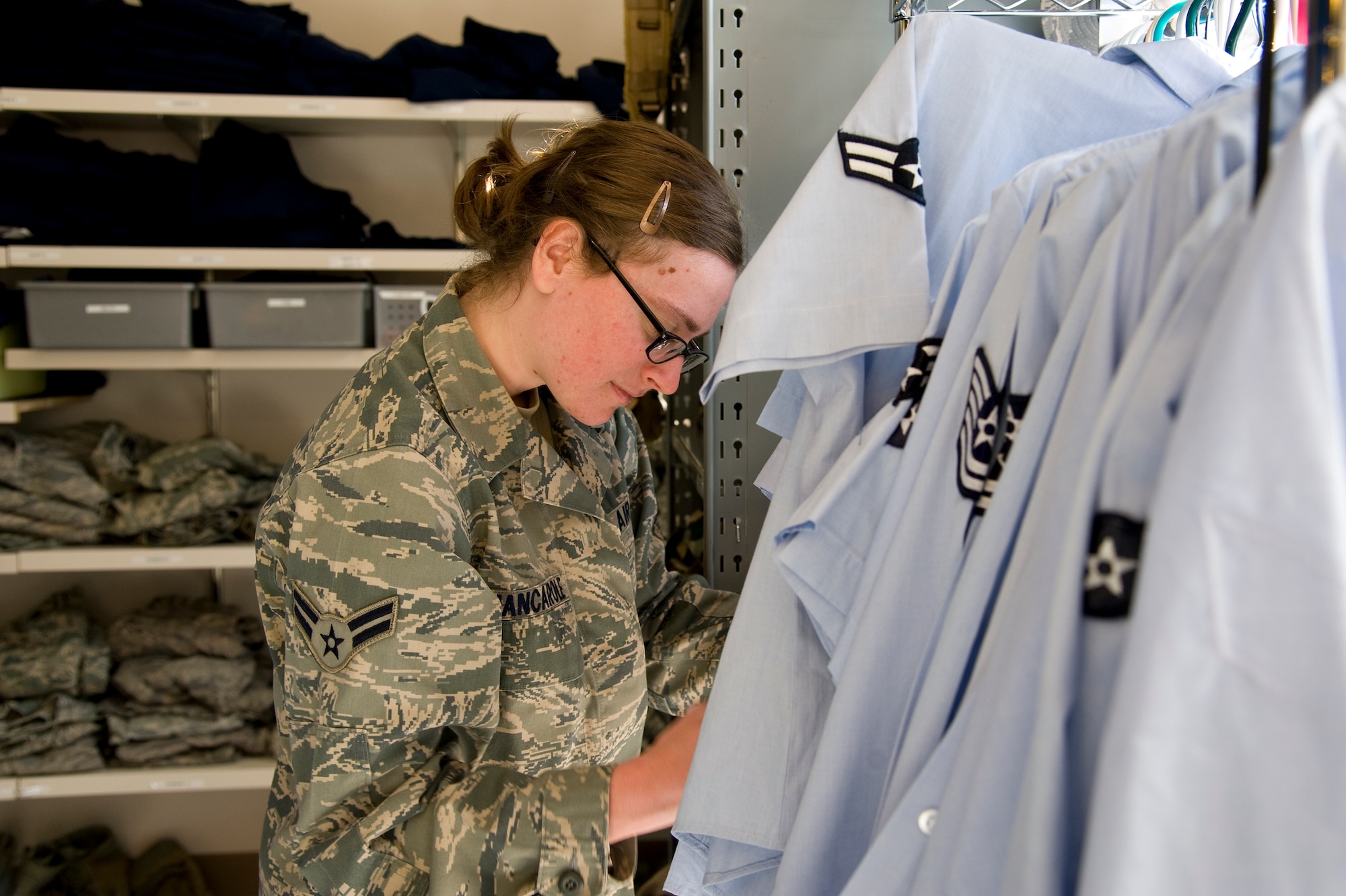 U.S. Air Force Airman 1st Class Danielle Jancarole, an intelligence analyst of 11th Intelligence Squadron, organizes blues uniform blouses at the Airman’s Attic on Hurlburt Field, Fla., Nov. 7, 2012. Active-duty Airmen volunteers coordinate with their units to lend a hand at the Airman’s Attic. (U.S. Air Force photo/ Airman 1st Class Michelle Vickers)

