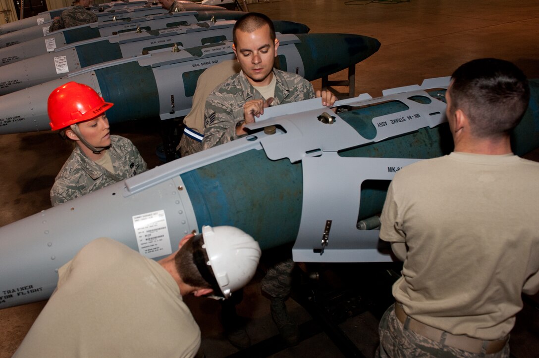 28th Munitions Squadron mission systems technicians build a Mark-84 inert bomb during training in the conventional maintenance shop at Ellsworth Air Force Base, S.D., Nov. 7, 2012. The munitions squadron carefully inspects and assembles 1,707 munitions items to train for combat operations, ensuring that Ellsworth B-1s continue to fly successful missions. (U.S. Air Force photo by Airman 1st Class Kate Thornton-Maurer/Released)